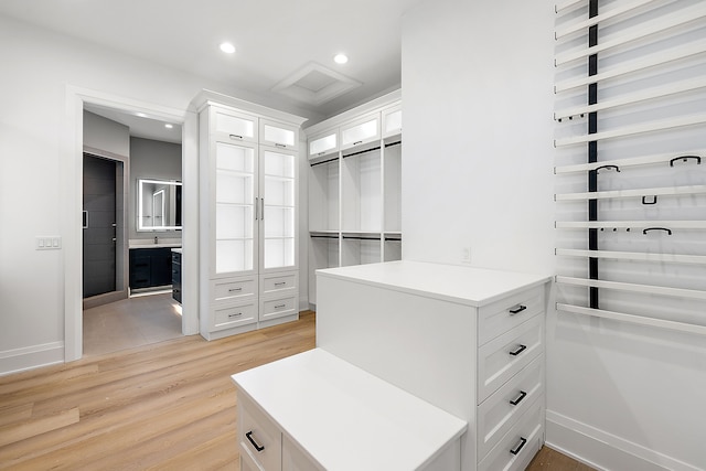 spacious closet featuring light hardwood / wood-style floors