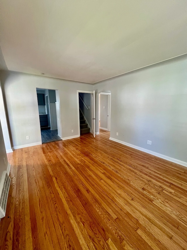 unfurnished living room featuring hardwood / wood-style flooring