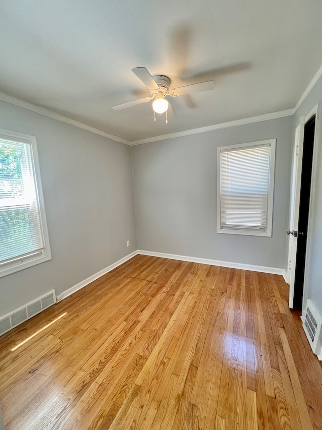 empty room featuring ceiling fan, light hardwood / wood-style floors, and ornamental molding