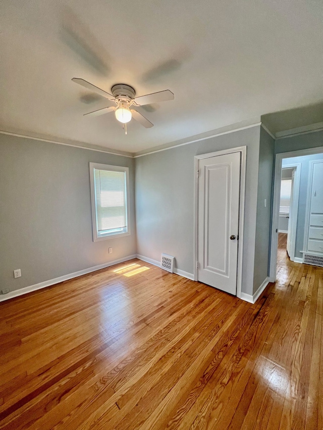 unfurnished room with ceiling fan, ornamental molding, and light hardwood / wood-style flooring