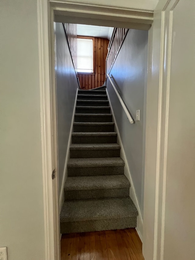 stairs featuring wood-type flooring