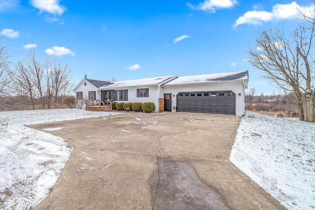 single story home with a garage and a wooden deck