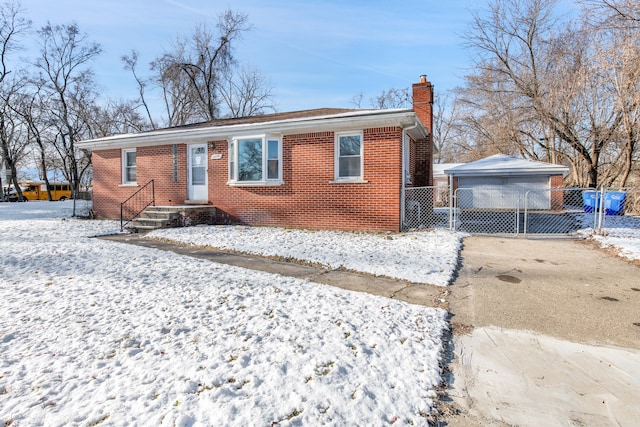 view of front of home with a garage and an outdoor structure