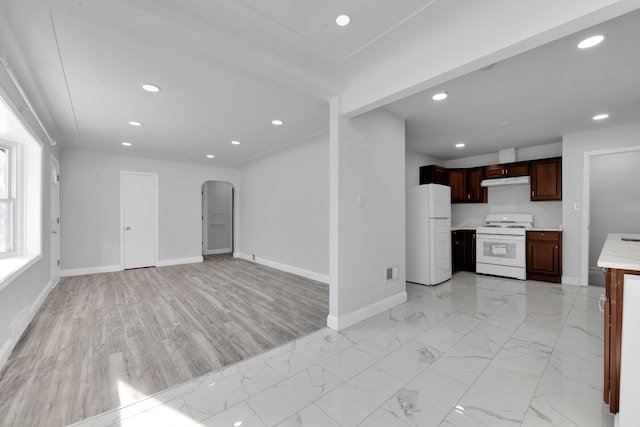 kitchen with dark brown cabinets and white appliances