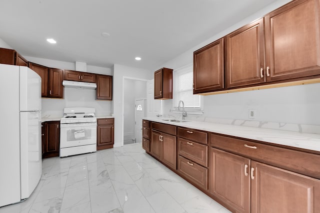 kitchen featuring sink, white appliances, and light stone countertops