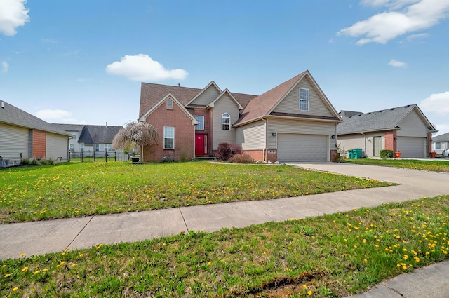 traditional-style home featuring a garage, fence, a front yard, brick siding, and concrete driveway