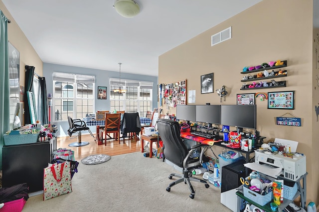 carpeted office space featuring visible vents