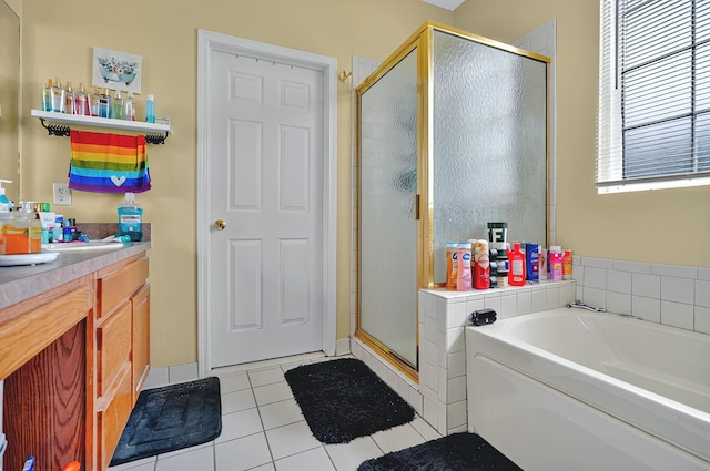 full bathroom with vanity, tile patterned flooring, a shower stall, and a garden tub