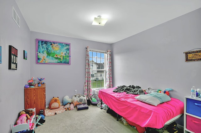 bedroom with visible vents and carpet flooring