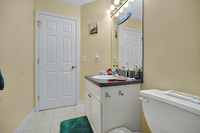 bathroom with tile patterned floors, baseboards, vanity, and toilet