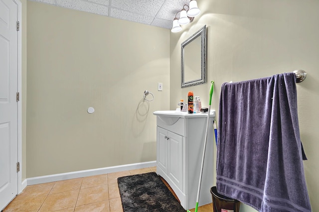 bathroom featuring baseboards, tile patterned floors, and vanity