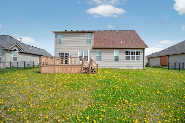 rear view of house featuring a lawn, a fenced backyard, and a wooden deck