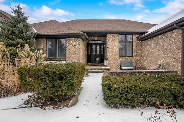 view of snow covered property entrance