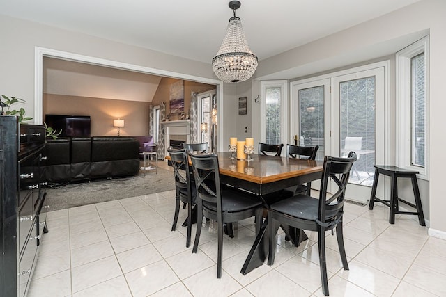 dining room featuring light tile patterned floors and a notable chandelier