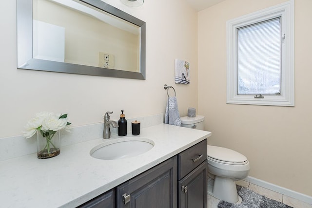 bathroom with vanity, tile patterned floors, and toilet