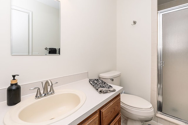 bathroom with vanity, an enclosed shower, and toilet