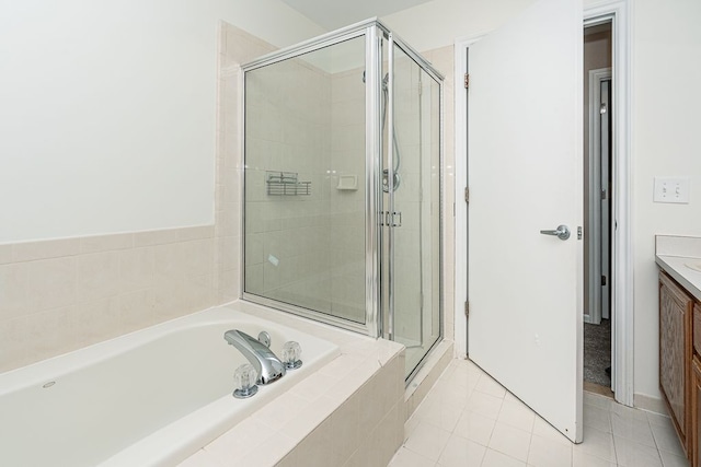 bathroom featuring vanity, tile patterned flooring, and shower with separate bathtub