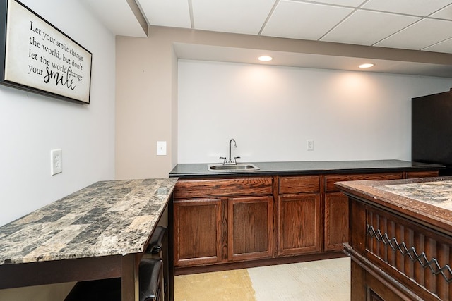 kitchen featuring sink and a drop ceiling