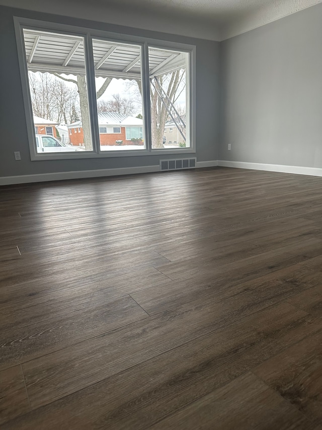 spare room with dark hardwood / wood-style flooring