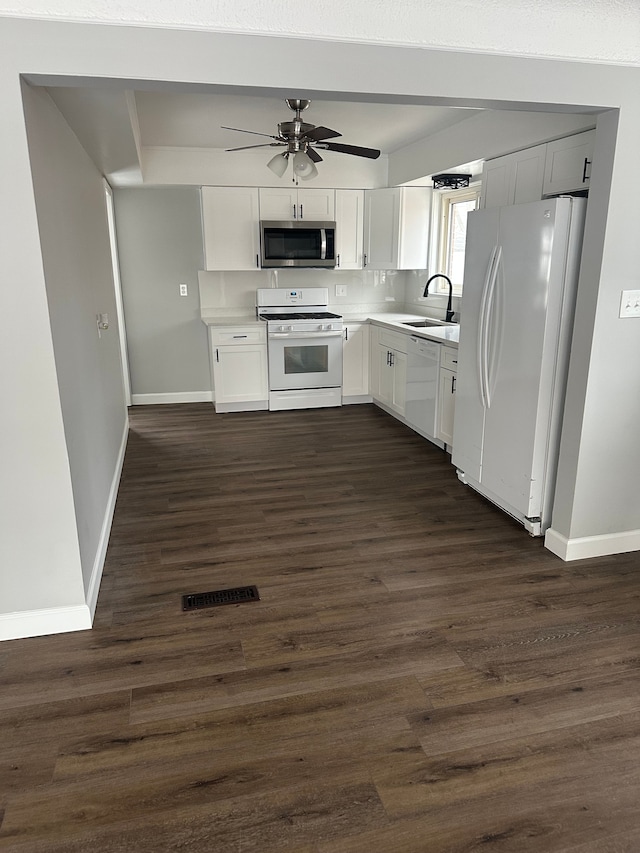 kitchen with ceiling fan, sink, tasteful backsplash, white appliances, and white cabinets