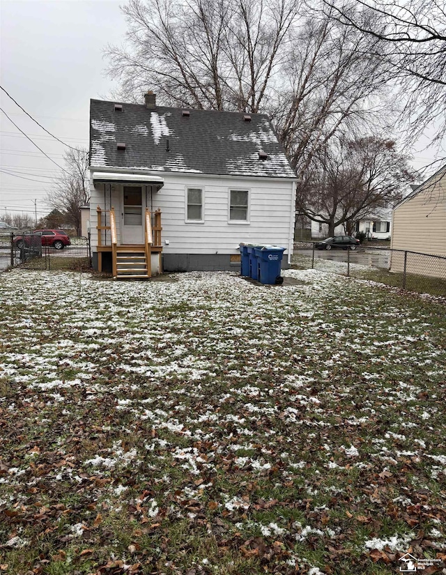 view of snow covered back of property