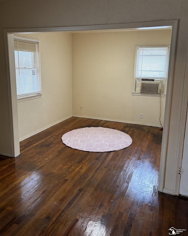 spare room featuring dark hardwood / wood-style floors and cooling unit