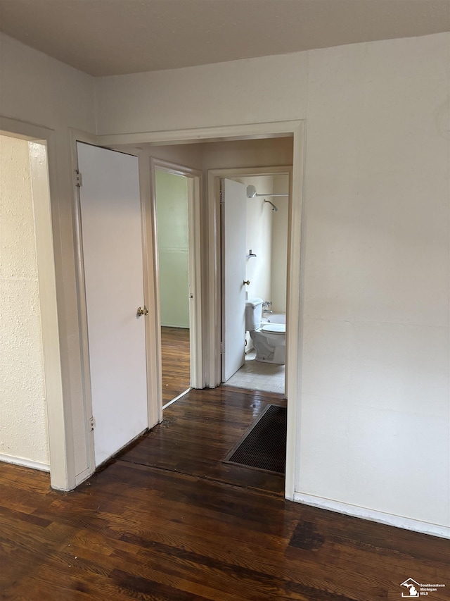 hall with dark hardwood / wood-style floors