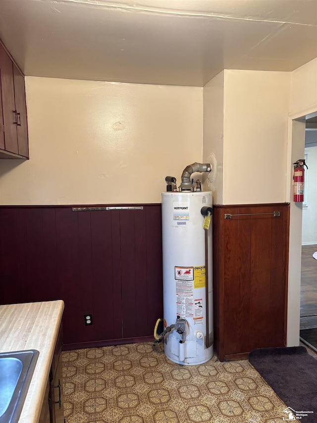 utility room with sink and gas water heater