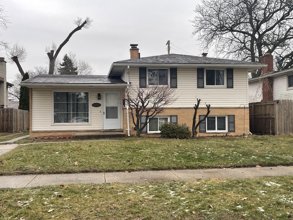 tri-level home with a front yard