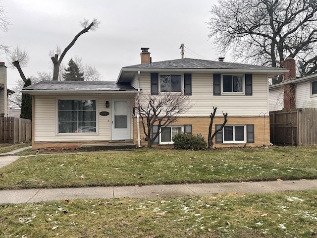 tri-level home with a front yard