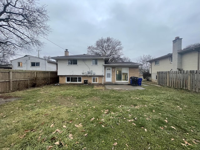 back of house with a lawn and a patio area