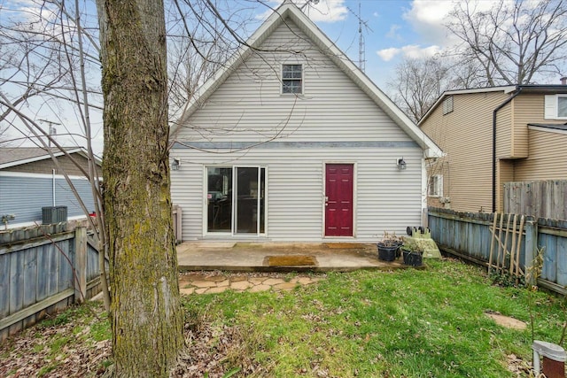 back of property featuring a yard, a fenced backyard, and a patio