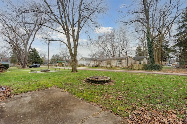 view of yard with a fire pit