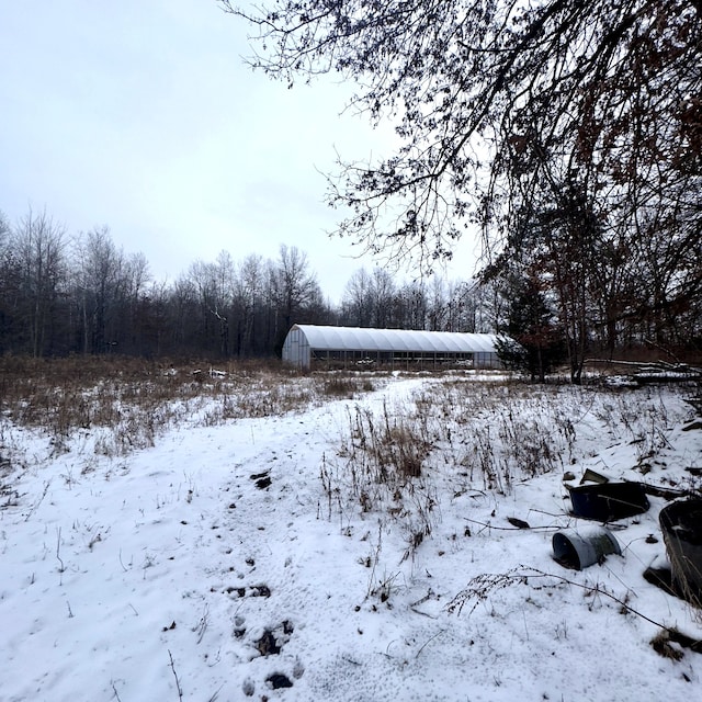 snowy yard with an outdoor structure