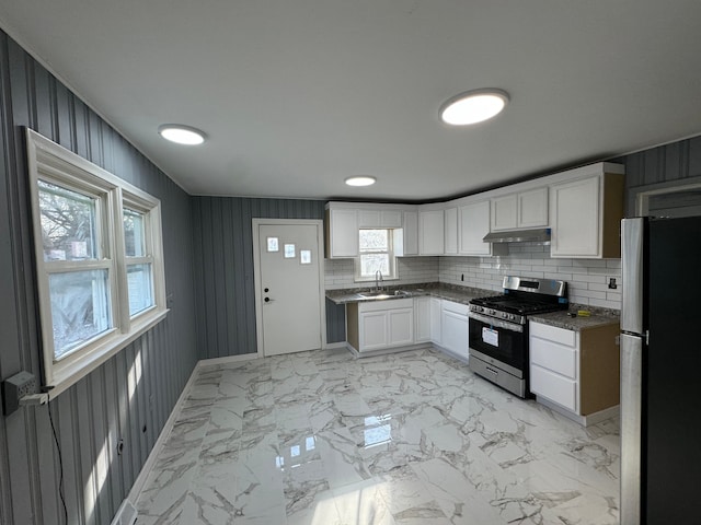 kitchen with backsplash, white cabinetry, sink, and appliances with stainless steel finishes