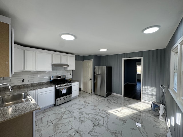 kitchen featuring white cabinets, sink, dark stone countertops, appliances with stainless steel finishes, and tasteful backsplash