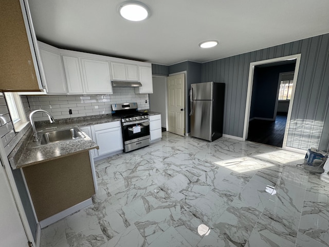 kitchen with white cabinets, appliances with stainless steel finishes, tasteful backsplash, and sink