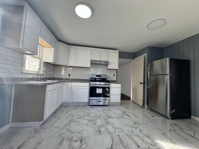 kitchen featuring decorative backsplash, white cabinetry, sink, and stainless steel appliances