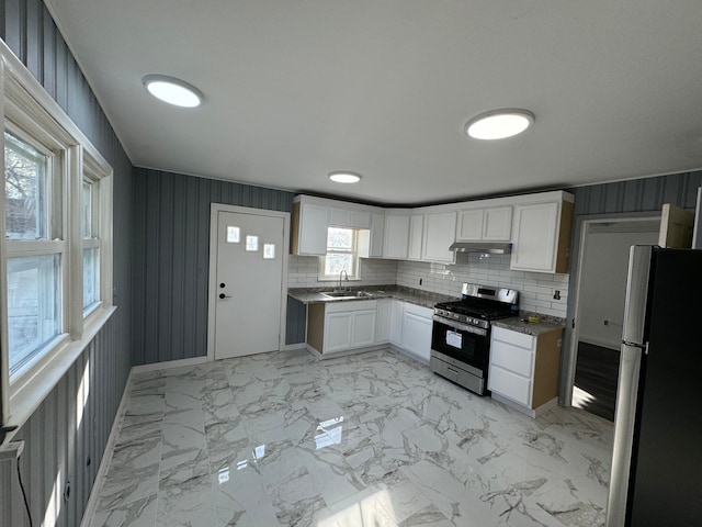 kitchen with white cabinets, appliances with stainless steel finishes, tasteful backsplash, and sink