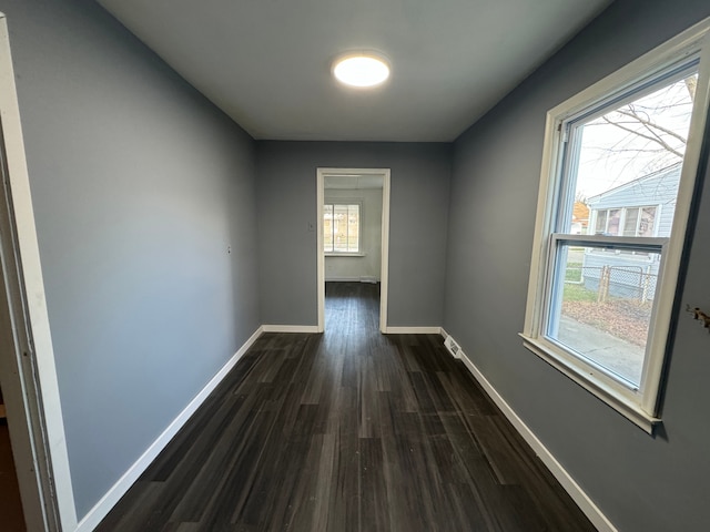 corridor with dark hardwood / wood-style flooring