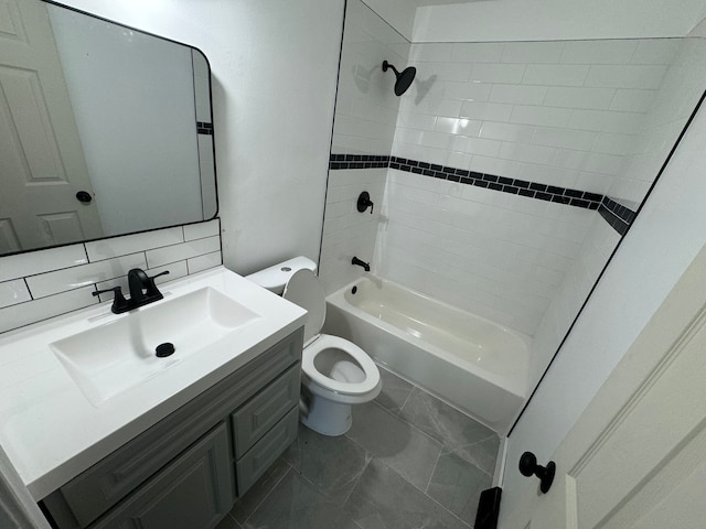 full bathroom with vanity, tiled shower / bath combo, tasteful backsplash, and toilet