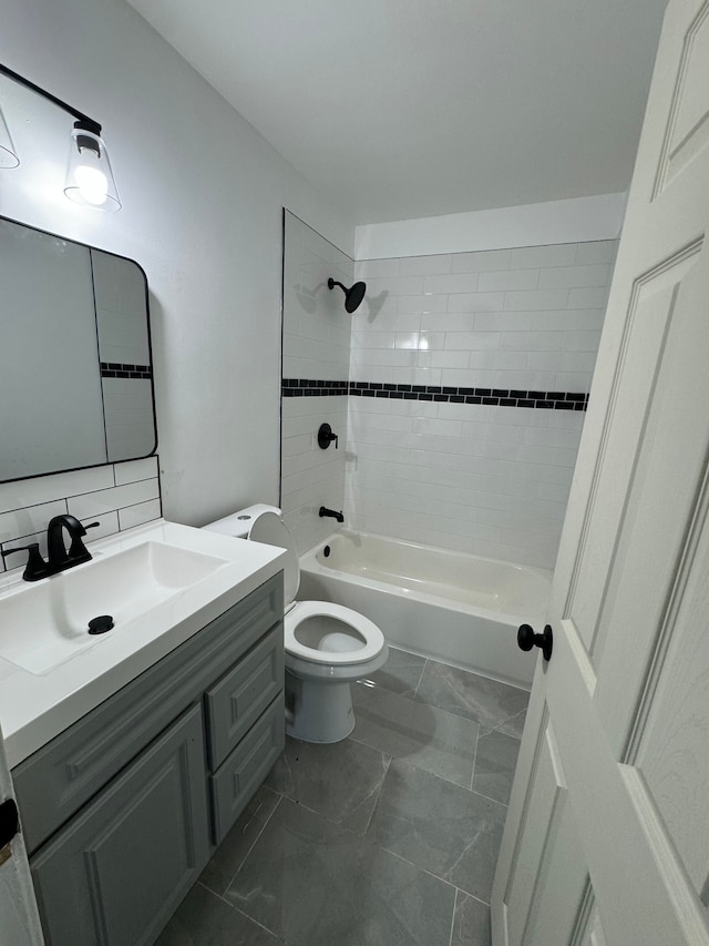 full bathroom featuring vanity, tiled shower / bath combo, toilet, and backsplash