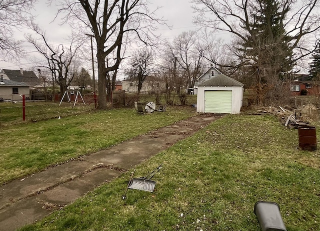 view of yard featuring a garage and an outdoor structure