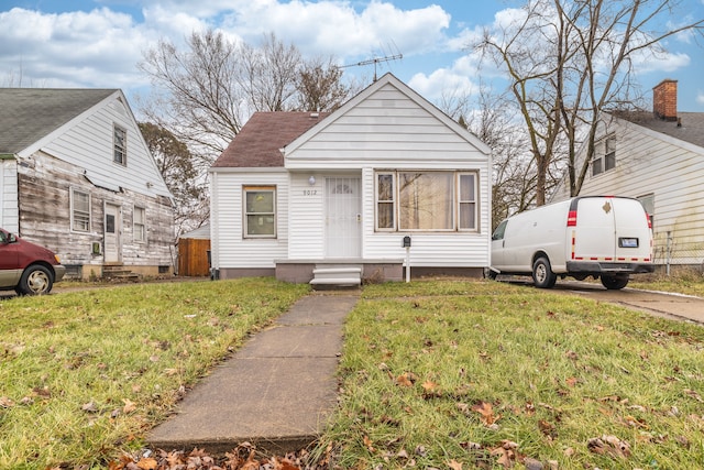 bungalow-style house with a front lawn