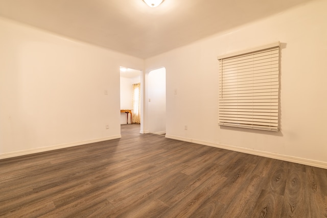 unfurnished room featuring dark wood-type flooring