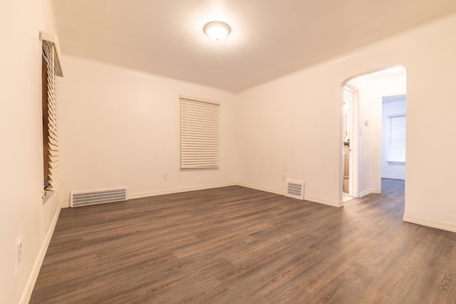 unfurnished room featuring dark hardwood / wood-style flooring