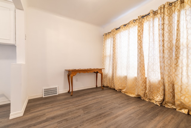 spare room with dark wood-type flooring