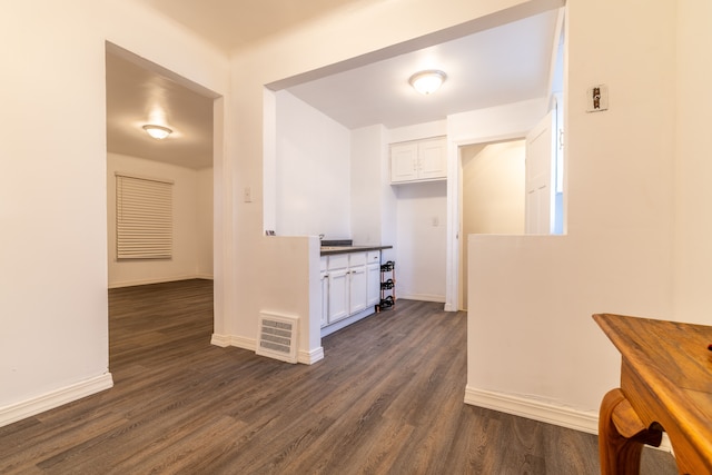 corridor with dark hardwood / wood-style flooring