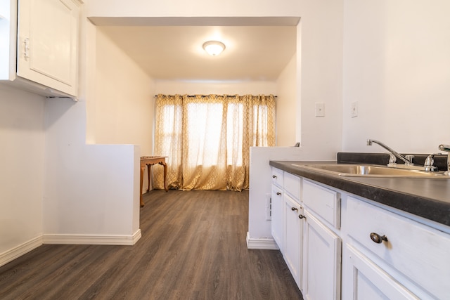 kitchen featuring sink, white cabinets, and dark hardwood / wood-style floors