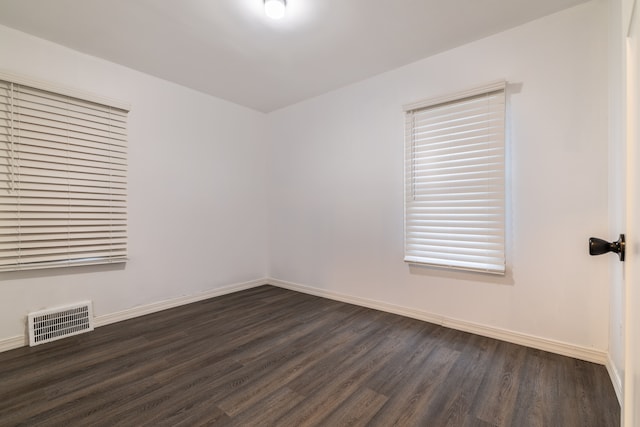 spare room with dark hardwood / wood-style flooring